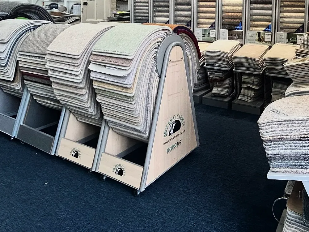 A Brockway Carpets display stand in the showroom, with carpet samples hung over it